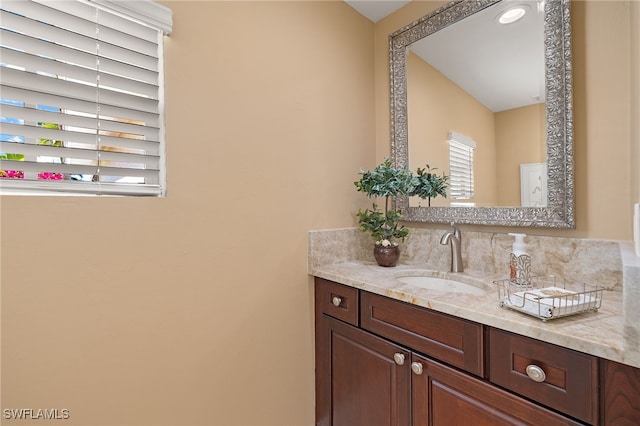 bathroom featuring vanity and tasteful backsplash