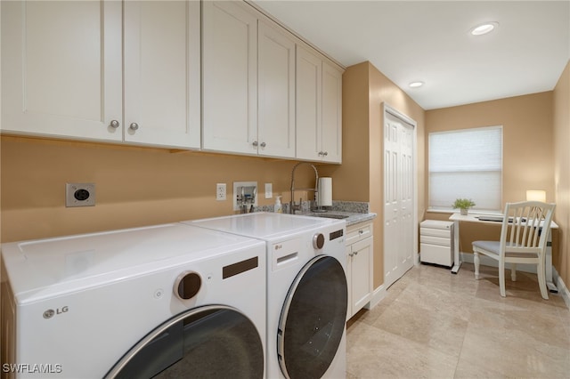 laundry area with cabinets, sink, and washing machine and dryer