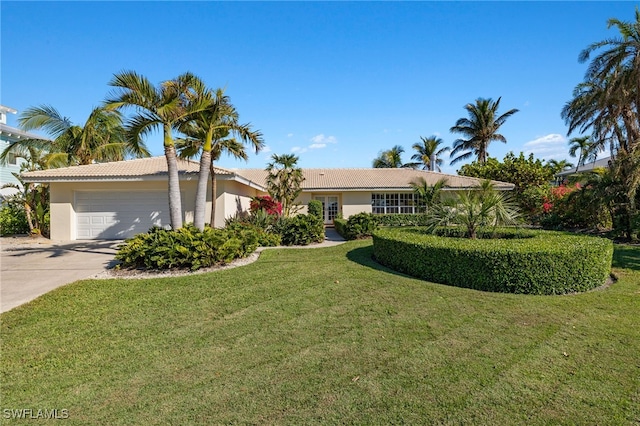 single story home featuring a front yard and a garage