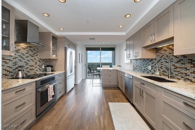 7515 Pelican Bay Blvd Unit 14A, Naples, FL 34108 - kitchen featuring stainless steel appliances, a sink, wall chimney range hood, dark wood-style floors, and gray cabinets