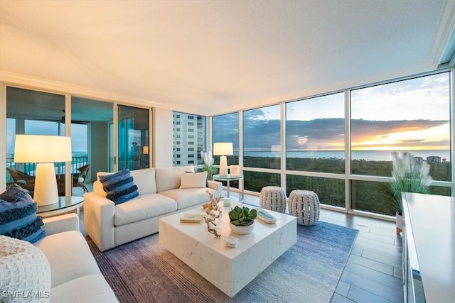 sunroom / solarium featuring a water view