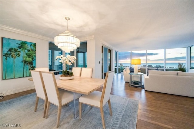 7515 Pelican Bay Blvd Unit 14A, Naples, FL 34108 - dining area with a chandelier, wood finished floors, crown molding, and baseboards