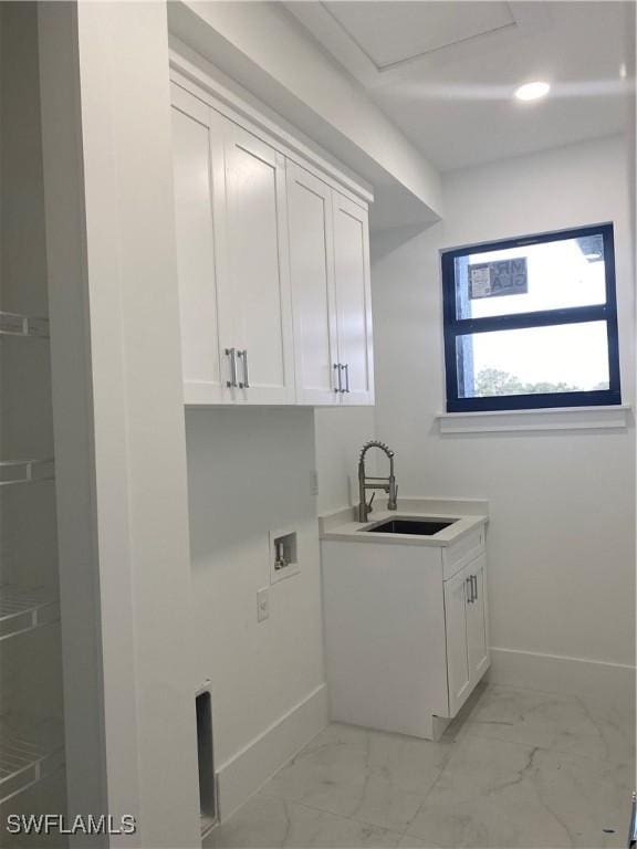 clothes washing area featuring cabinets, sink, and hookup for a washing machine