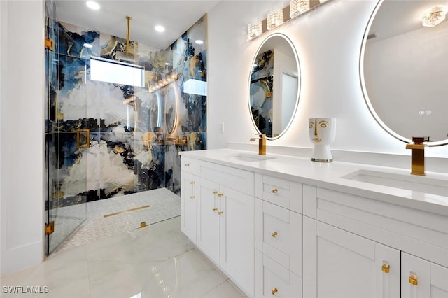 bathroom featuring a tile shower and vanity