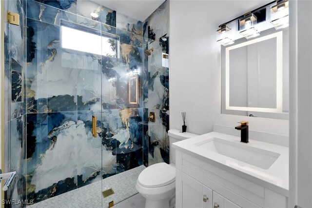 bathroom featuring vanity, toilet, and an enclosed shower