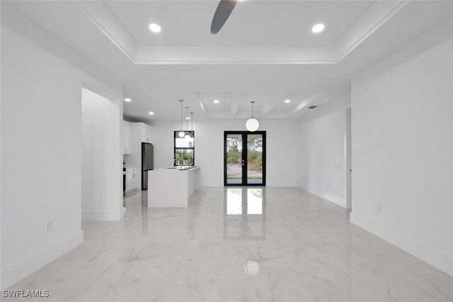 unfurnished room featuring a tray ceiling, ceiling fan, french doors, and crown molding