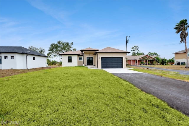 view of front of home with a front lawn and a garage