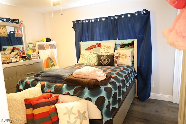 bedroom with dark hardwood / wood-style flooring