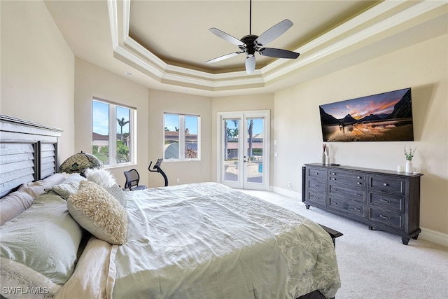 carpeted bedroom featuring ceiling fan, a raised ceiling, crown molding, and access to outside