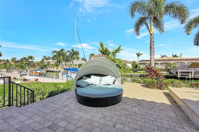 view of patio / terrace featuring a water view and a boat dock