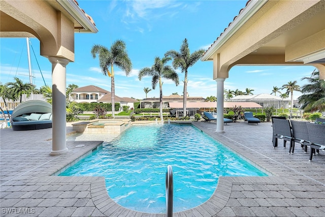 view of pool featuring an in ground hot tub and a patio area