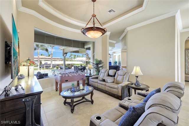 tiled living room with crown molding and a tray ceiling