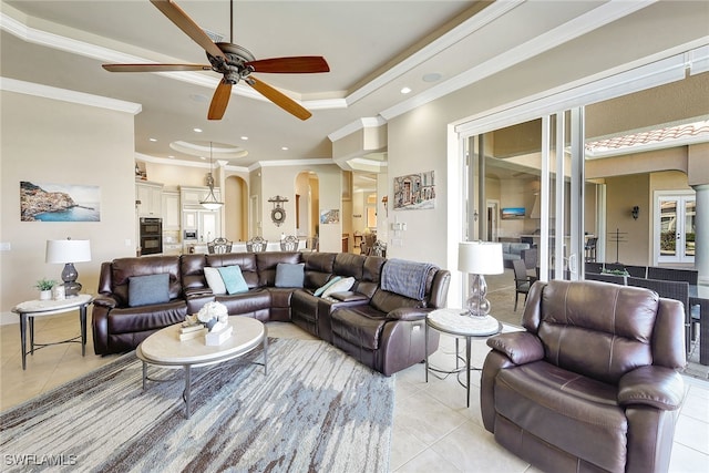 living room with light tile patterned floors, ceiling fan, and ornamental molding