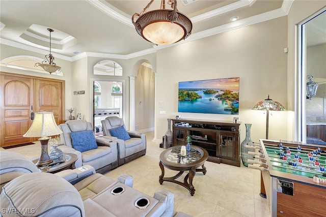 tiled living room with a raised ceiling, ornamental molding, and decorative columns