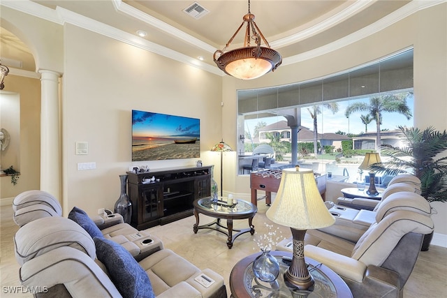 tiled living room with a tray ceiling, ornate columns, and crown molding