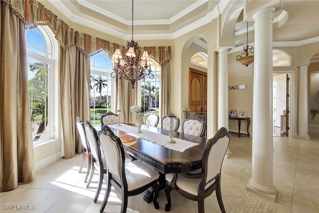 tiled dining area featuring ornate columns, crown molding, and a chandelier