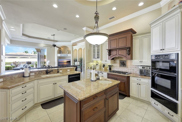 kitchen featuring light stone countertops, ceiling fan, black appliances, sink, and hanging light fixtures