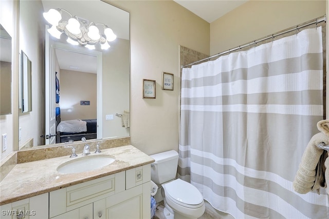 bathroom featuring vanity, curtained shower, toilet, and a chandelier