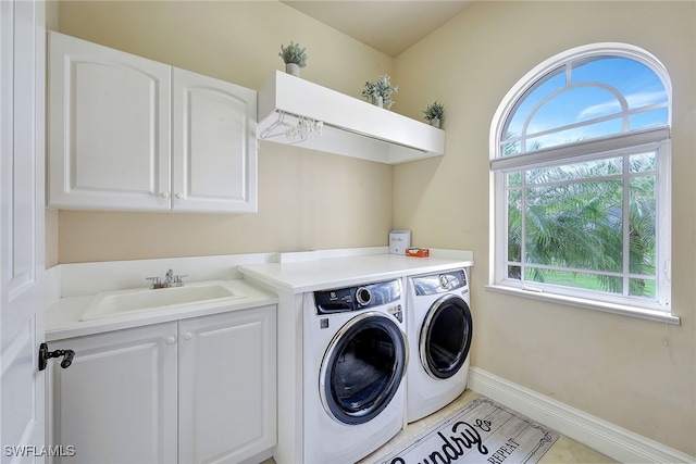 laundry room with cabinets, sink, and washing machine and clothes dryer