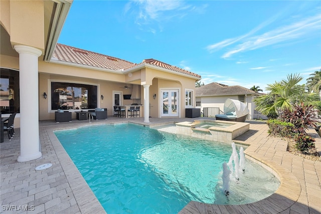 view of swimming pool featuring an in ground hot tub, a bar, a patio, and outdoor lounge area