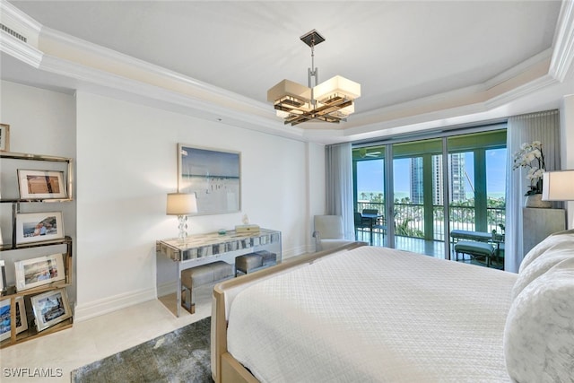 bedroom featuring access to exterior, a tray ceiling, an inviting chandelier, and ornamental molding