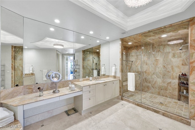 bathroom with vanity, a tray ceiling, and walk in shower