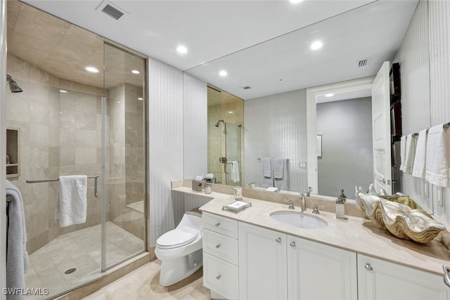 bathroom with toilet, vanity, and walk in shower