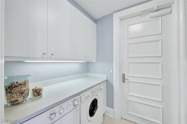 laundry room featuring cabinets and separate washer and dryer