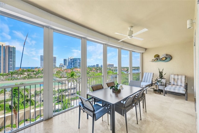 sunroom featuring ceiling fan