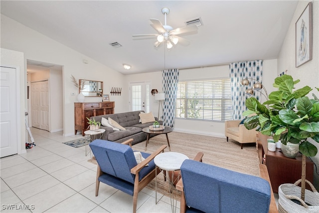 living room with ceiling fan, french doors, light tile patterned floors, and vaulted ceiling