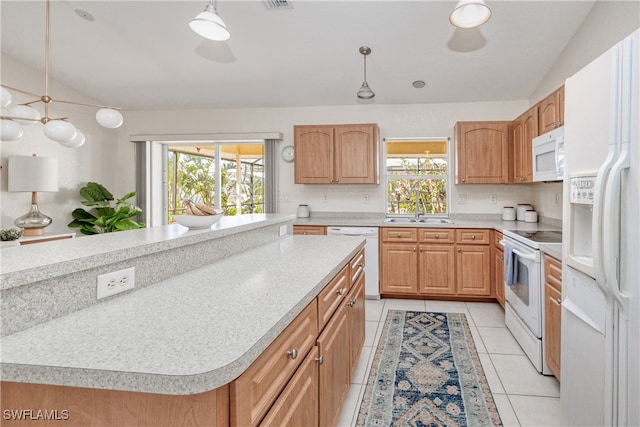 kitchen featuring a center island, white appliances, hanging light fixtures, and a wealth of natural light