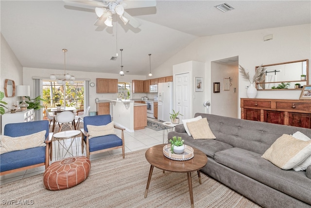 tiled living room featuring ceiling fan with notable chandelier and vaulted ceiling