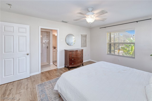 bedroom featuring ceiling fan, light wood-type flooring, and connected bathroom