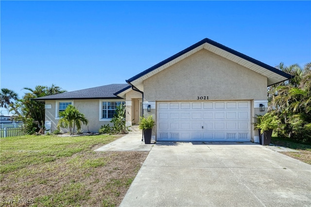 ranch-style house featuring a front lawn and a garage