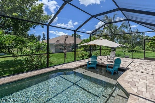 view of swimming pool featuring a lanai, a lawn, and a patio area