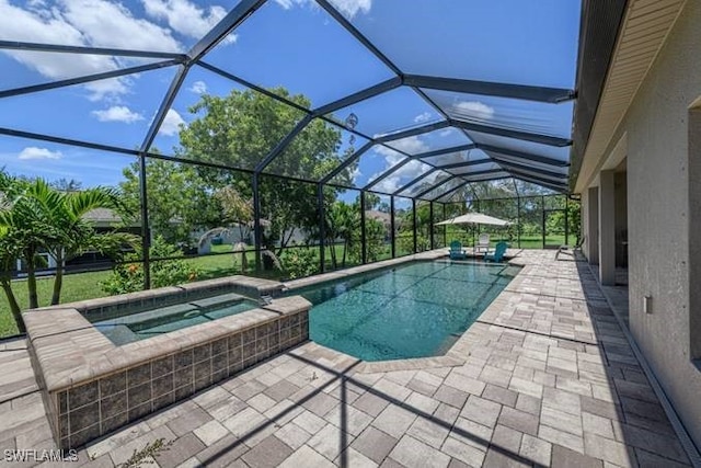 view of pool featuring a patio, an in ground hot tub, and glass enclosure