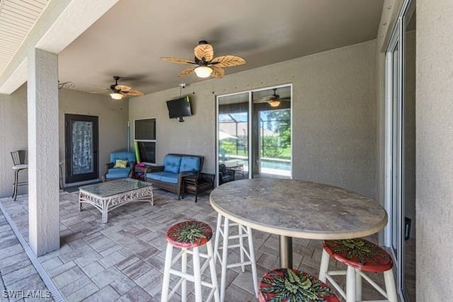 view of patio with outdoor lounge area and ceiling fan