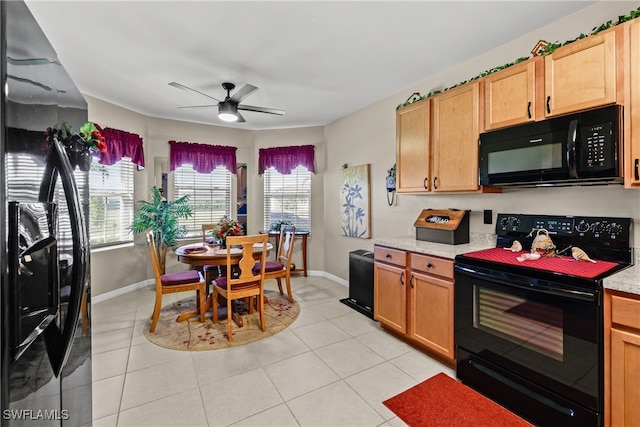 kitchen featuring light tile patterned floors, ceiling fan, and black appliances