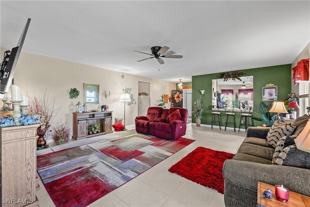 tiled living room featuring ceiling fan and a healthy amount of sunlight