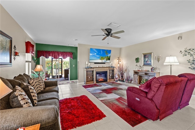 living room featuring light tile patterned floors and ceiling fan