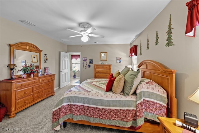 bedroom with ceiling fan and light carpet