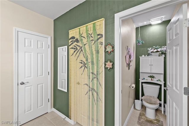 bathroom featuring tile patterned flooring and toilet