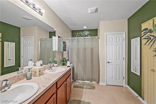 bathroom featuring vanity, tile patterned floors, and curtained shower