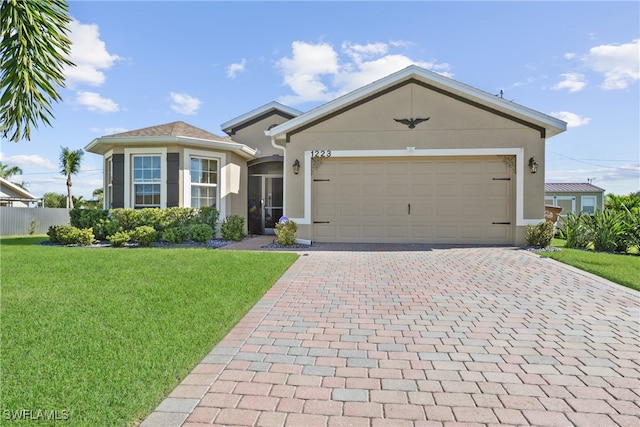 view of front of property with a garage and a front yard