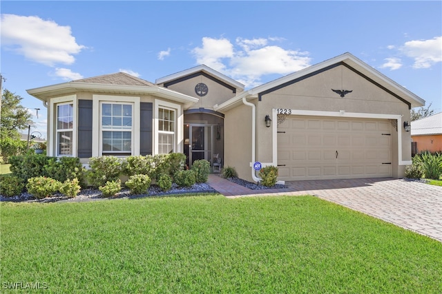 view of front of property featuring a front yard and a garage