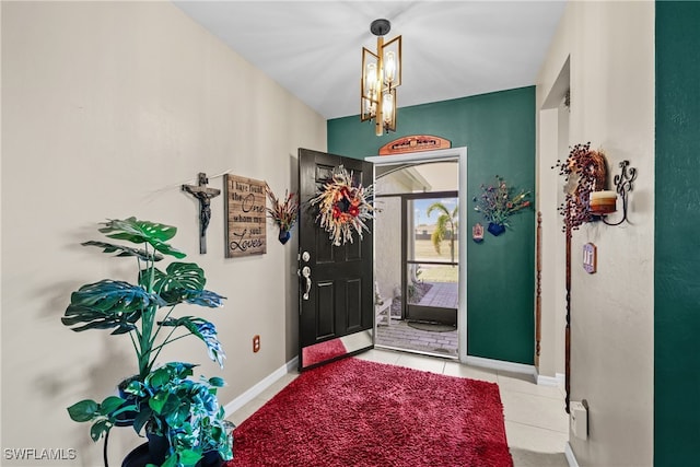 tiled foyer with a notable chandelier