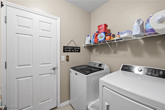 clothes washing area with washing machine and dryer