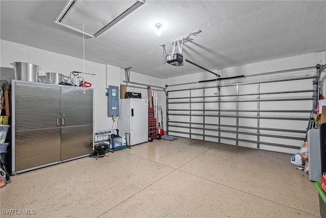 garage with electric panel and a garage door opener