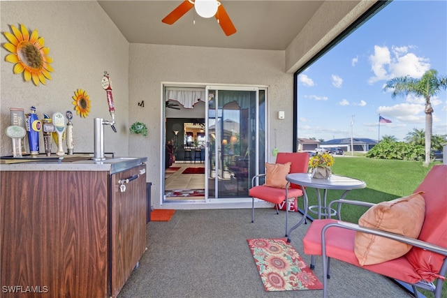 exterior space with ceiling fan and sink