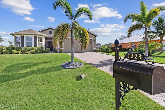 view of front of property with a front yard and a garage